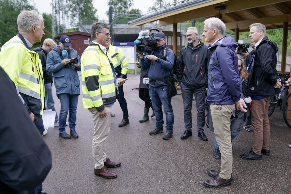 Norway's Prime Minister Jonas Gahr Store and Norway's Transport Minister Jon-Ivar Nygard attend the media at the site damaged by flood at Leirsund station in Leirsund, Norway, Wednesday Aug. 9, 2023. Landslides were reported overnight across mountainous southern Norway with police on Wednesday saying more than 600 people have been evacuated in the region north of Oslo. For days, the storm battered parts of Scandinavia and the Baltics, leading to rivers and streams going over their banks. (Stian Lysberg/NTB Scanpix via AP)