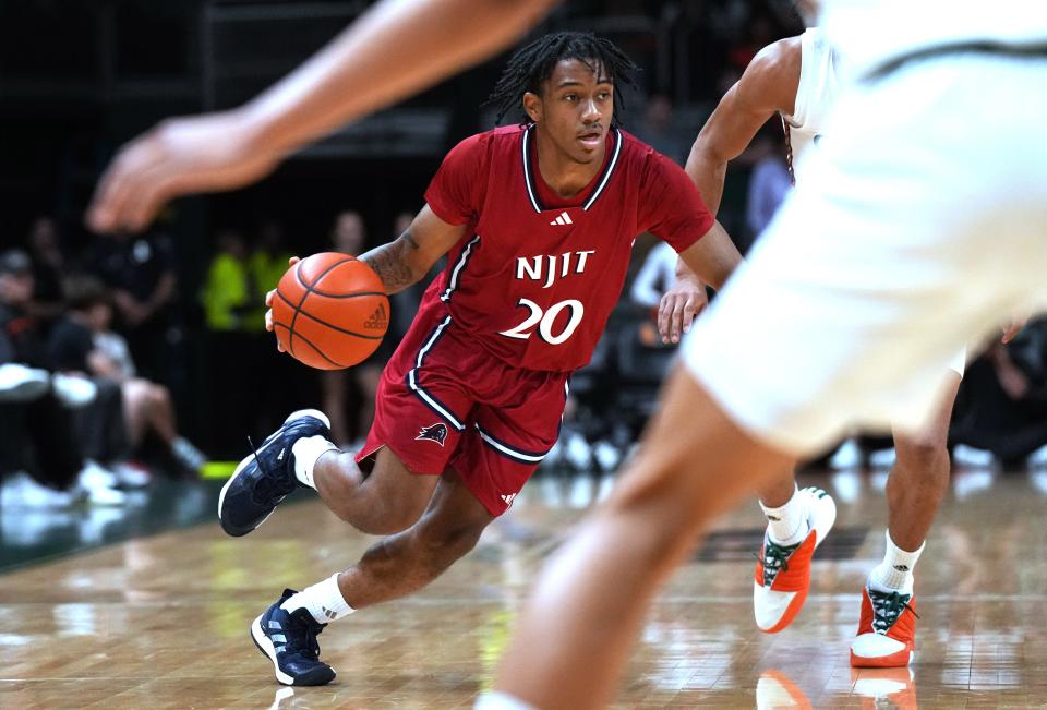 Nov 6, 2023; Coral Gables, Florida, USA; N.J.I.T Highlanders guard Tariq Francis (20) drives toward the basket against the Miami (Fl) Hurricanes in the second half at Watsco Center. Mandatory Credit: Jim Rassol-USA TODAY Sports