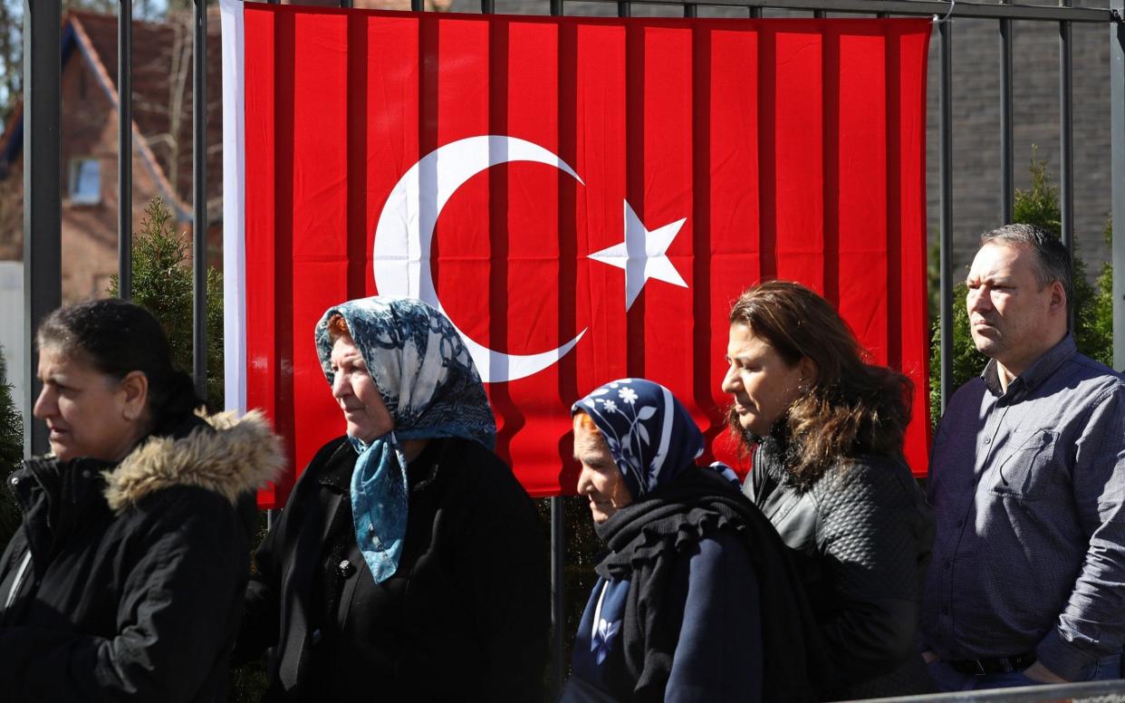 Turkish citizens line up outside the Turkish consulate to cast their votes in the Turkish referendum in Berlin - Getty Images Europe