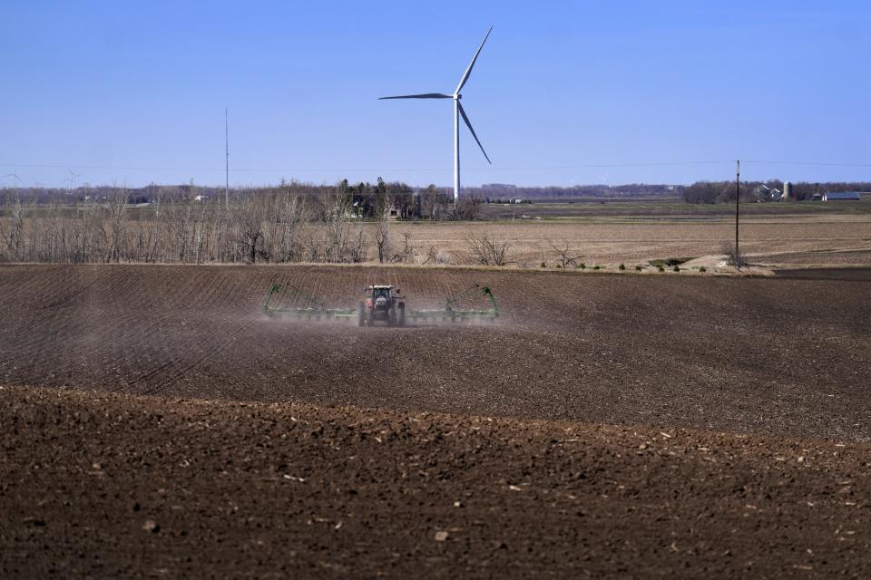 FILE - Corn is planted with a view of wind turbines on April 2, 2023, in Lake Benton, Minn. (AP Photo/Jessie Wardarski, File)