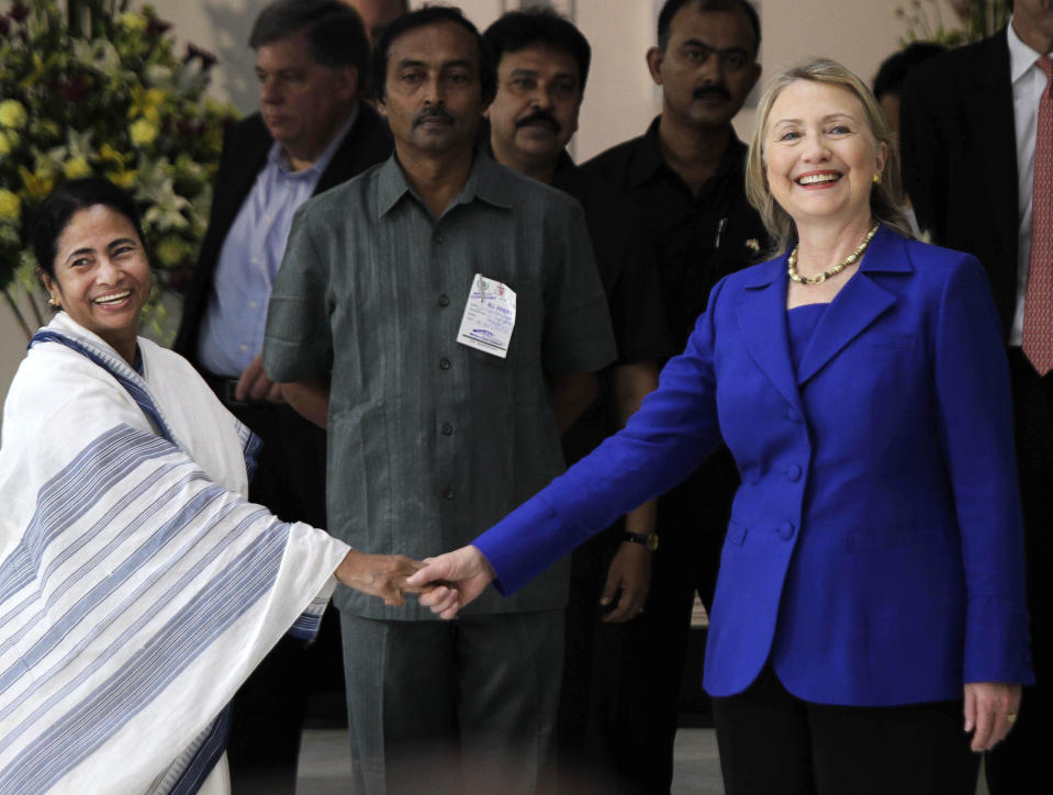 West Bengal Chief Minister Mamata Banerjee, left, shakes hands with U.S. Secretary of State Hillary Rodham Clinton before a meeting in Kolkata, India, Monday, May 7, 2012. Clinton met with Banerjee, a key partner of India's ruling coalition who has stymied government efforts to lift restrictions on foreign-owned investments in the country. (AP Photo/Bikas Das)