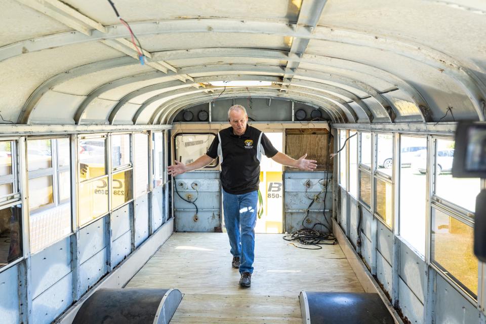 Jason Rodgers, instructor of Rutherford High School's Construction Academy, discusses the "school-bus-to-tiny-house" conversion project