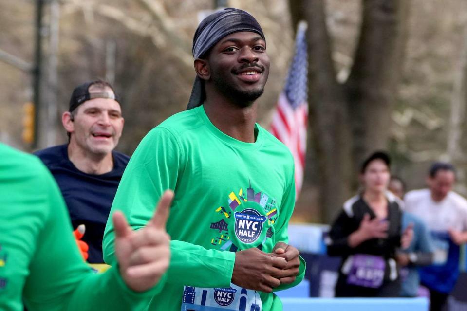 <p>Mike Stobe/Getty</p> Lil Nas X runs the New York City Half Marathon on 17 March, 2024