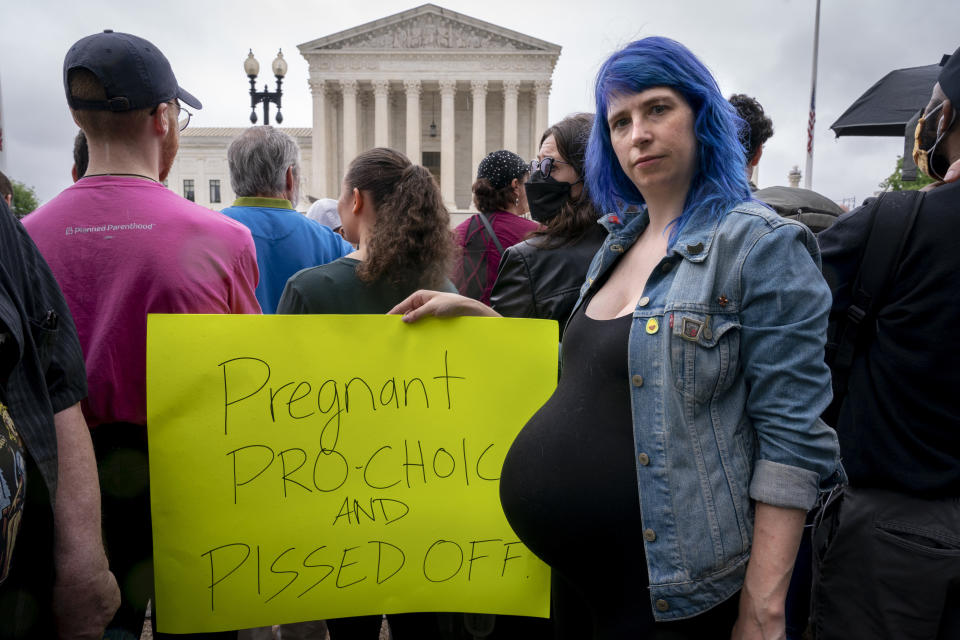 Kiki Fox, 34, of Washington, who is 8 months pregnant, poses for a portrait as she joins abortion rights demonstrators, Saturday, May 14, 2022, outside the Supreme Court in Washington, during protests across the country. Fox, who sells technology software, was eight months pregnant at the time she has photographed. She has since given birth to a daughter. "I honestly don't know what's next. It's tough because I'm a D.C. resident, and we don't get as much say in politics as we want. I've been encouraging people who do have representation to call their senators, and I've spent a lot of time donating to abortion funds, and to people who are there to get people to states where abortion is legal," she said. "I'm definitely not going to sit back and say, 'OK, whatever.' "(AP Photo/Jacquelyn Martin)