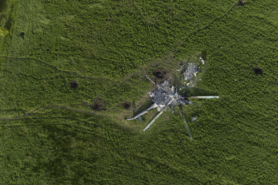 The remains of a destroyed Russian helicopter lie in a field in the village of Malaya Rohan, Kharkiv region, Ukraine, Monday, May 16, 2022. (AP Photo/Bernat Armangue)