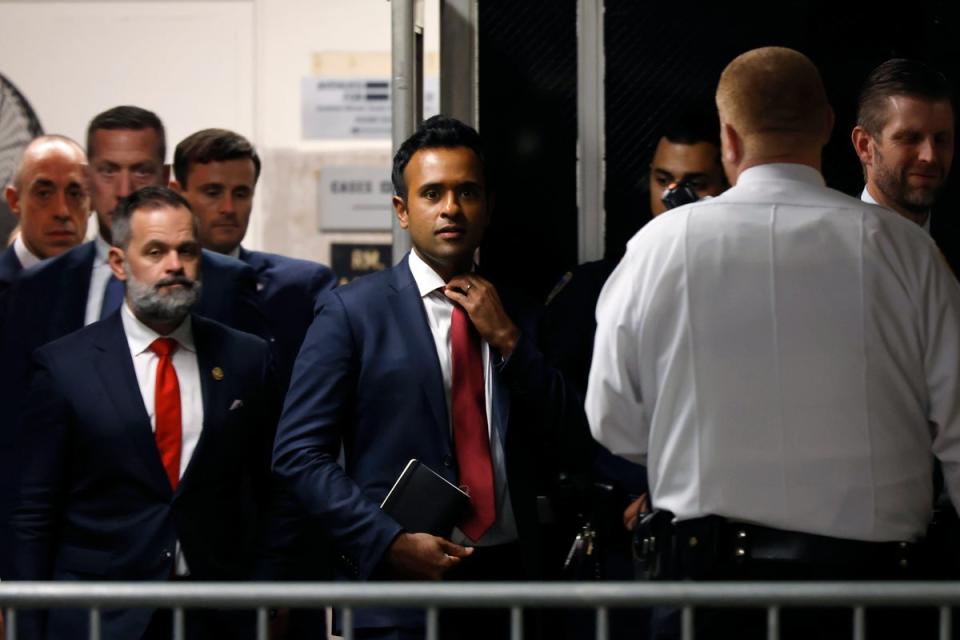 Vivek Ramaswamy, center, and US Rep Cory Mills, left, enter a Manhattan courtroom to observe Donald Trump’s hush money trial on 14 May. (EPA)