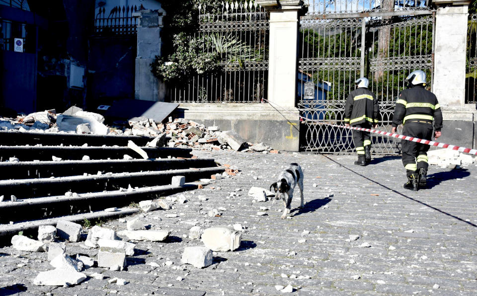 Debris stand in front of a damaged building in Fleri, near the Sicilian city of Catania, Italy, Wednesday, Dec. 26, 2018. A quake triggered by Mount Etna’s ongoing eruption jolted eastern Sicily before dawn Wednesday, injuring 10 people, damaging churches and houses in hamlets on the volcano’s slopes and prompting panicked villagers to flee their homes. (Orietta Scardino/ANSA Via AP)