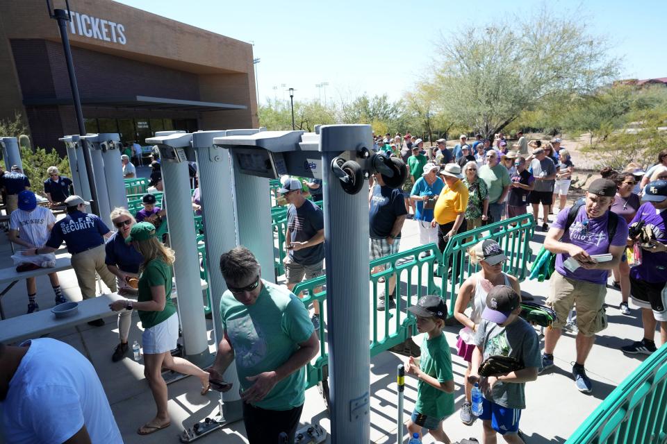 Baseball fans enter the gates for the Diamondbacks' first spring training game of 2022 against the Rockies at Salt River Fields.