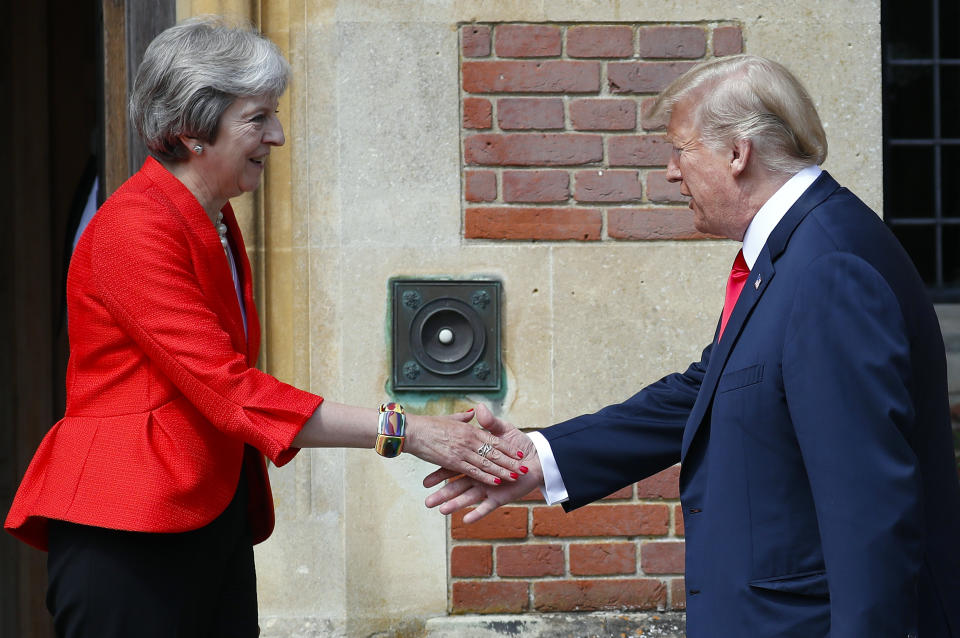 U.S. President Donald Trump, right, is greeted by British Prime Minister Theresa May, left, at Chequers, in Buckinghamshire. (Credit: AP Photo/Pablo Martinez Monsivais)