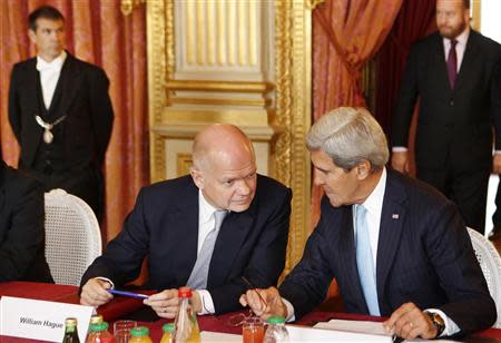 U.S. Secretary of State John Kerry (R) speaks to British Foreign Secretary William Hague at the P3 Foreign Ministers Meeting to discuss Syria, at the Quai d'Orsay in Paris September 16, 2013. REUTERS/Larry Downing