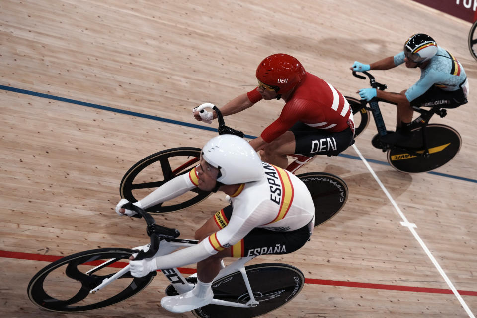 Members of Team Spain, Team Denmark and Team Belgium compete during the track cycling men's madison race at the 2020 Summer Olympics, Saturday, Aug. 7, 2021, in Izu, Japan. (AP Photo/Thibault Camus)