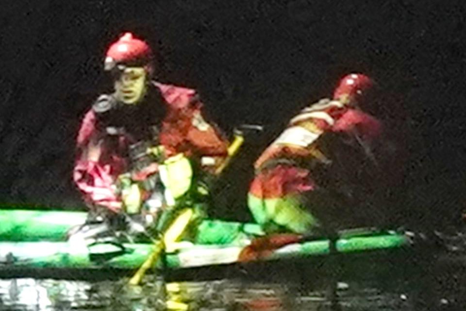 Emergency personnel search the lake at the scene in Babbs Mill Park in Kingshurst, Solihull (PA)