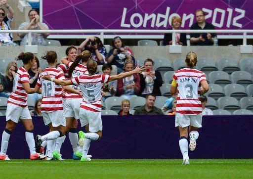 United States's forward Abby Wambach (3rd L) celebrates after scoring the opening goal during their London 2012 Olympic Games women's football quarter-final match against New Zealand at St James' Park in Newcastle, north-east England. The United States won 2-0