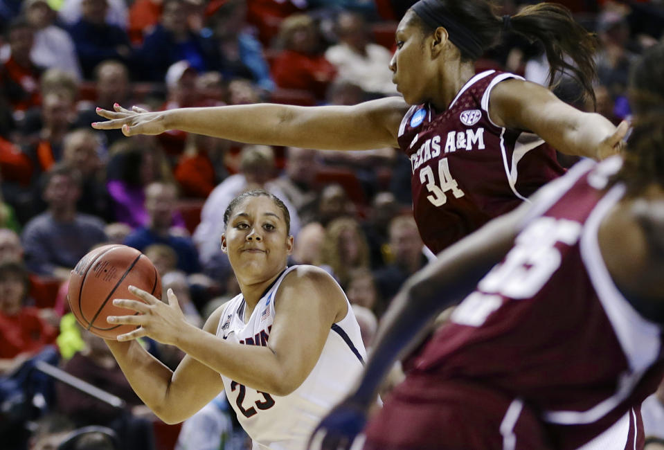 Connecticut's Kaleena Mosqueda-Lewis (23) looks to pass the ball against the defense of Texas A&M's Karla Gilbert (34) during the first half of a regional final game in the NCAA college basketball tournament in Lincoln, Neb., Monday, March 31, 2014. (AP Photo/Nati Harnik)