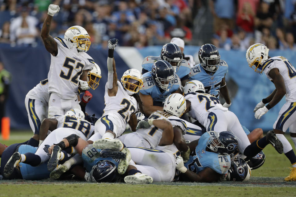 Los Angeles Chargers defenders celebrate after stopping the Tennessee Titans on a fourth-down play late in the fourth quarter of an NFL football game Sunday, Oct. 20, 2019, in Nashville, Tenn. (AP Photo/James Kenney)