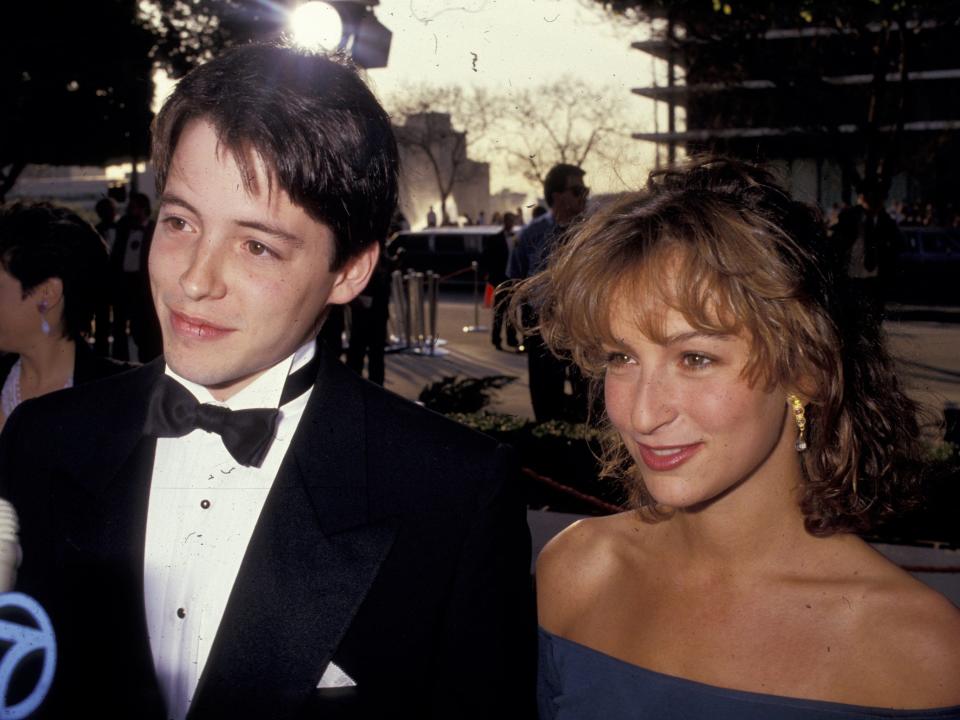 Matthew smiling in a tuxedo and bowtie and Jennifer smiling in an off-the-shoulder blue dress.