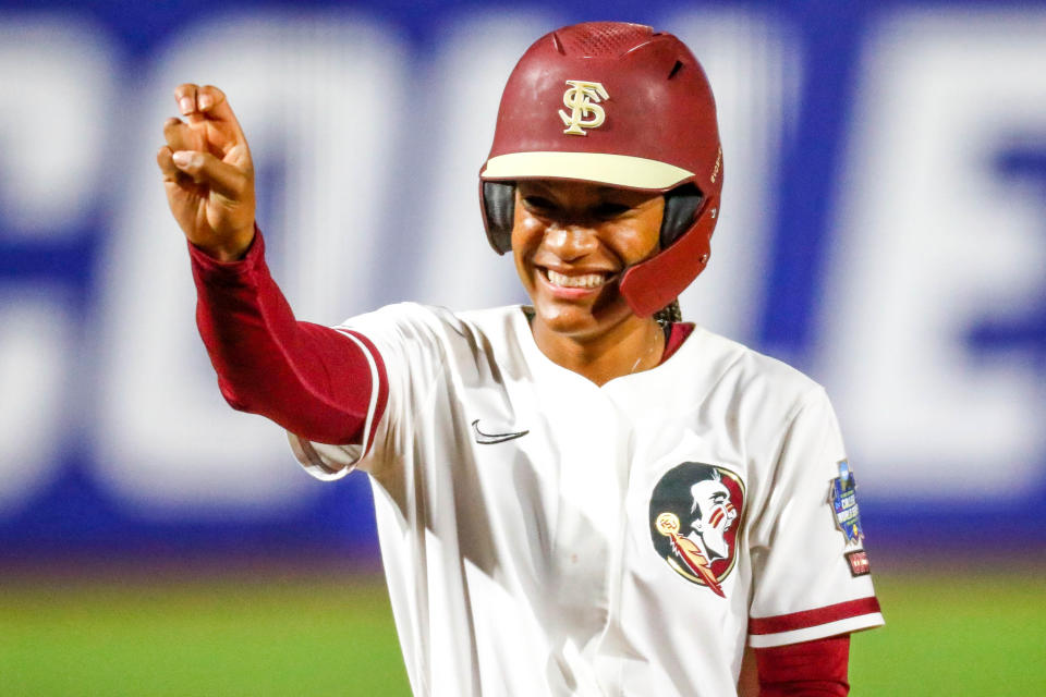 Florida State infielder Amaya Ross (12) waves to her team from third base during the Women's College World Series against Oklahoma State in June.