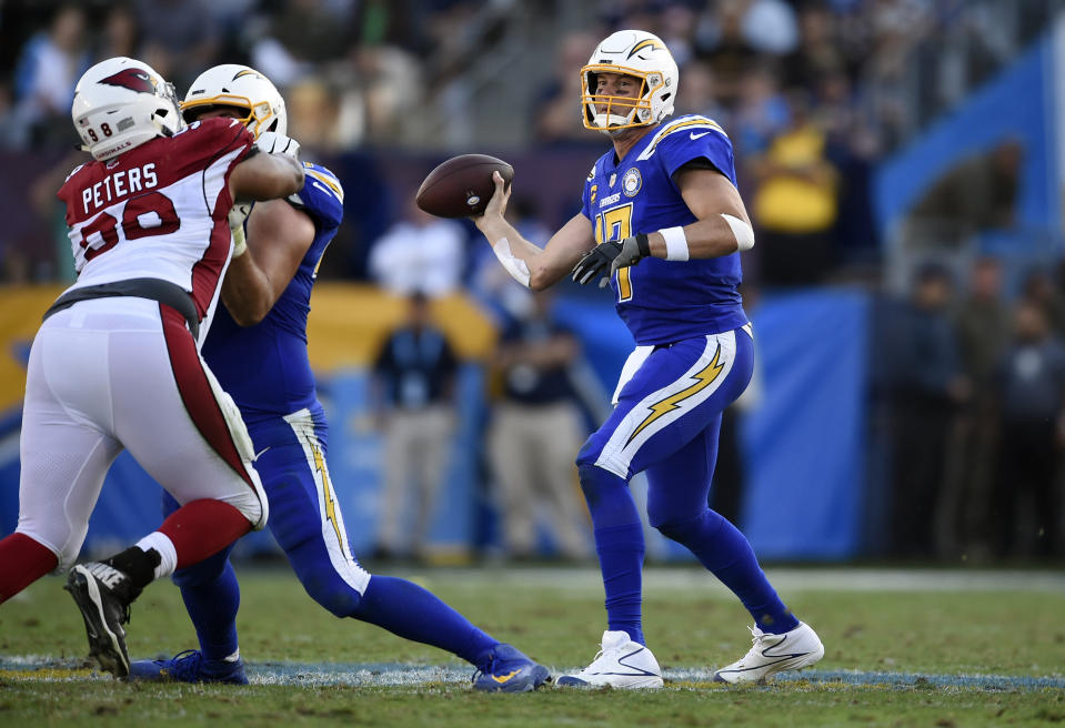 Los Angeles Chargers quarterback Philip Rivers, right, throws against the Arizona Cardinals during the second half of an NFL football game Sunday, Nov. 25, 2018, in Carson, Calif. (AP Photo/Kelvin Kuo )