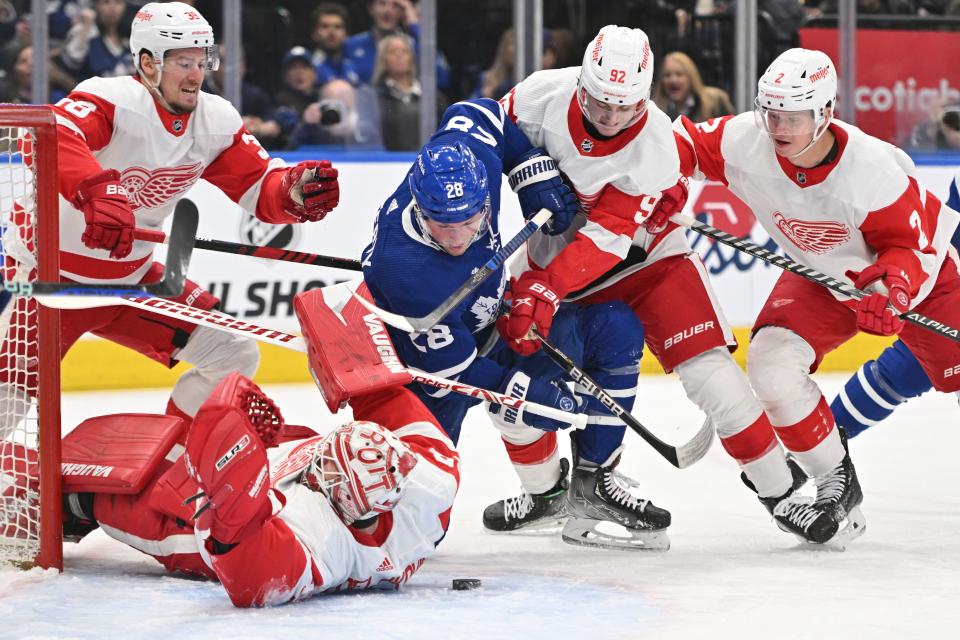 Toronto Maple Leafs forward Sam Lafferty (28) battles for a loose puck with Detroit Red Wings forward Marco Kasper (92) in front of goalie Alex Nedeljkovic (39) in the first period at Scotiabank Arena in Toronto on Sunday, April 2, 2023.
