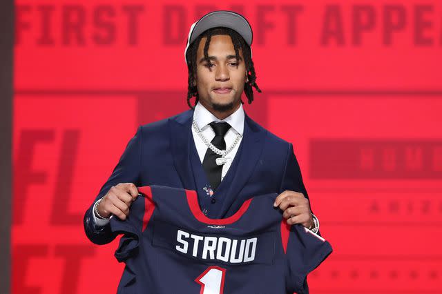 <p>Scott Winters/Icon Sportswire via Getty</p> C.J. Stroud with a jersey after being drafted in the first round of the NFL Draft on April 27, 2023.