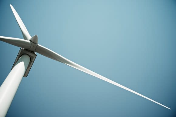 A wind turbine under a blue sky