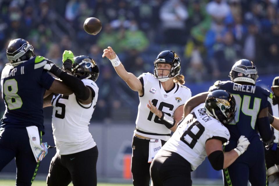 Jacksonville Jaguars quarterback Trevor Lawrence throws against the Seattle Seahawks during the first half of an NFL football game, Sunday, Oct. 31, 2021, in Seattle. (AP Photo/Stephen Brashear)