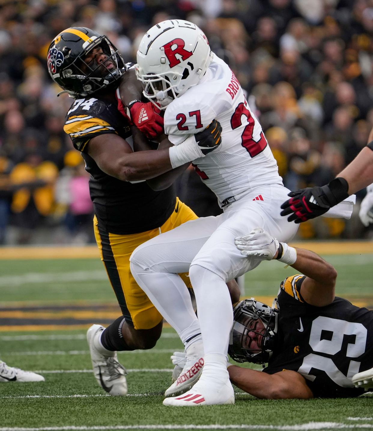 Iowa linebacker Jay Higgins (34) stops Rutgers running back Samuel Brown V (27) during the first half of an NCAA college football game, Saturday, Nov. 11, 2023, in Iowa City, Iowa. (AP Photo/Bryon Houlgrave)