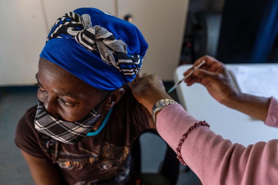 A woman is vaccinated against Covid at the Lenasia South Hospital, near Johannesburg (AP)