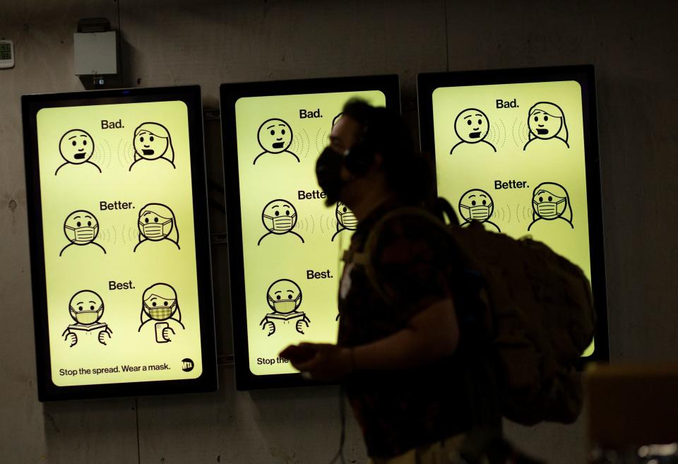 A sign displays mask-wearing information at Penn Station in New York in 2021.