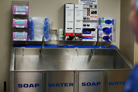 Masks, gloves and soap are stacked ready above a scrub sink in an operating room at Johns Hopkins hospital in Baltimore, Maryland, U.S., May 13, 2019. REUTERS/Rosem Morton