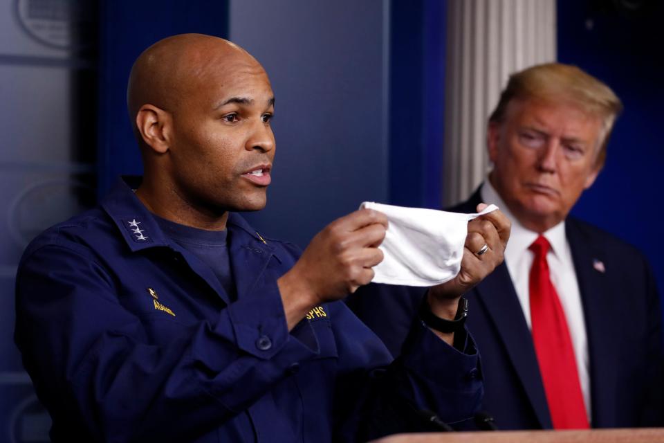 President Donald Trump watches as U.S. Surgeon General Jerome Adams holds up his COVID-19 face mask on April 22, 2020.