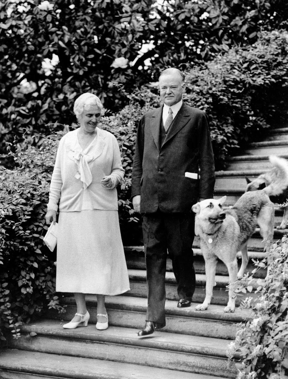 President Herbert Hoover and first lady Lou Henry Hoover with their dog King Tut.