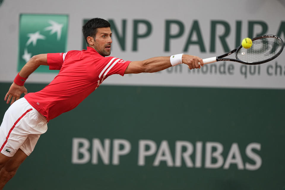 Serbia's Novak Djokovic stretches to return the ball to Italy's Matteo Berrettini during their quarterfinal match of the French Open tennis tournament at the Roland Garros stadium Wednesday, June 9, 2021 in Paris. (AP Photo/Michel Euler)