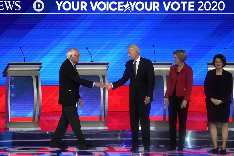 Democratic presidential hopefuls Vermont Senator Bernie Sanders, former Vice President Joe Biden, Massachusetts Senator Elizabeth Warren, Minnesota Senator Amy Klobuchar and Billionaire activist Tom Steyer arrive onstage for the eighth Democratic primary debate of the 2020 presidential campaign season co-hosted by ABC News, WMUR-TV and Apple News at St. Anselm College in Manchester, New Hampshire, on February 7, 2020.