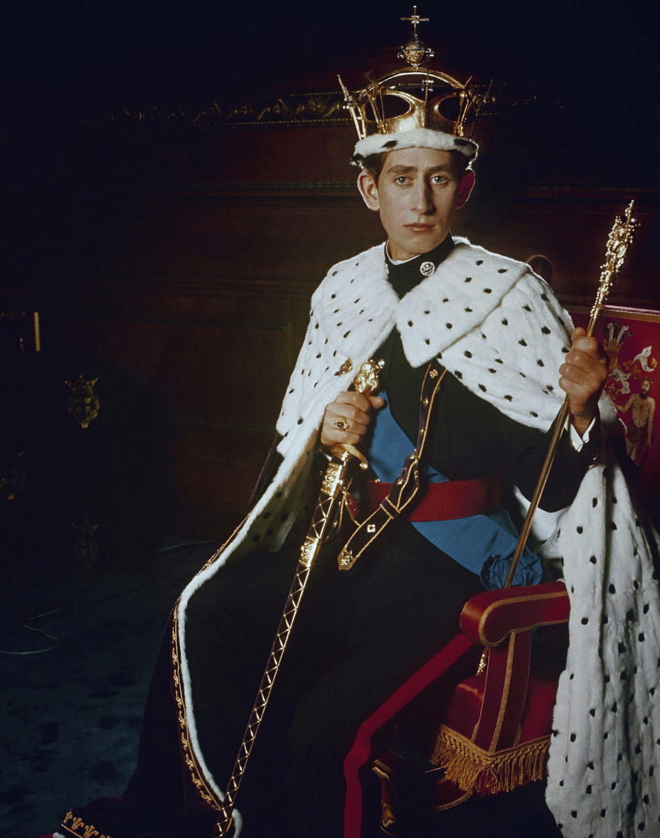 FILE - In this 1969 file photo, Britain's Prince Charles, poses for a photo dressed in his investiture regalia as Prince of Wales. Prince Charles turns 70 on Wednesday Nov. 14, 2018, serving as heir to the throne since he was a young child, but his destiny is to be king.(Pool Photo via AP, File)