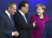 China's Prime Minister Li Keqiang, center, speaks with German Chancellor Angela Merkel, right, and European Council President Donald Tusk, left, during a group photo during an EU-ASEM summit in Brussels, Friday, Oct. 19, 2018. EU leaders met with their Asian counterparts Friday to discuss trade, among other issues. (AP Photo/Francisco Seco)