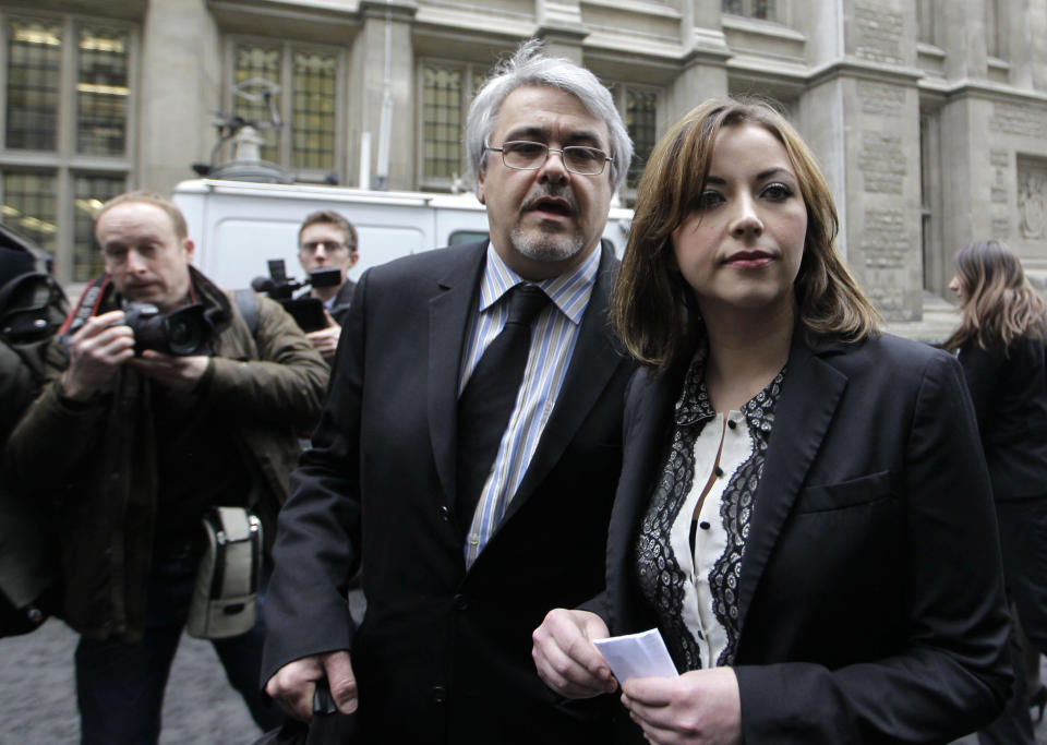 Singer Charlotte Church, right, leaves the High Court in London after hearing the reading of a statement setting out the terms of the settlement for phone hacking damages claim against News International, Monday, Feb. 27, 2012. Church, who testified before a media inquiry of being hounded by Rupert Murdoch's journalists when she was a teen singing sensation, received 600,000 pounds ($951,000) Monday in a phone hacking settlement from News International and said she had been sickened by what she had learnt about intrusion into her private life. (AP Photo/Sang Tan)