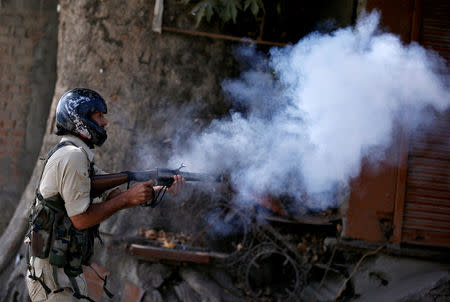 An Indian policeman fires a teargas shell towards demonstrators during a protest against the recent killings in Kashmir, in Srinagar September 23, 2016. REUTERS/Danish Ismail/File Photo