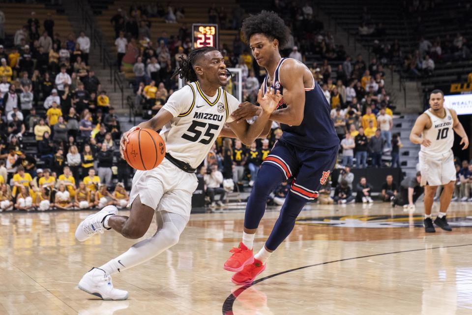 Missouri's Sean East II, left, drives past Auburn's Aden Holloway during the second half of an NCAA college basketball game Tuesday, March 5, 2024, in Columbia, Mo. (AP Photo/L.G. Patterson)