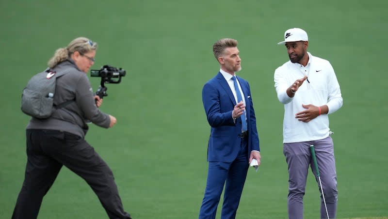 Tony Finau, right, is interviewed on the second hole during a practice round in preparation for the Masters at Augusta National Golf Club Tuesday, April 9, 2024, in Augusta, Ga. The Utah native is among the favorites to claim the Green Jacket this week.