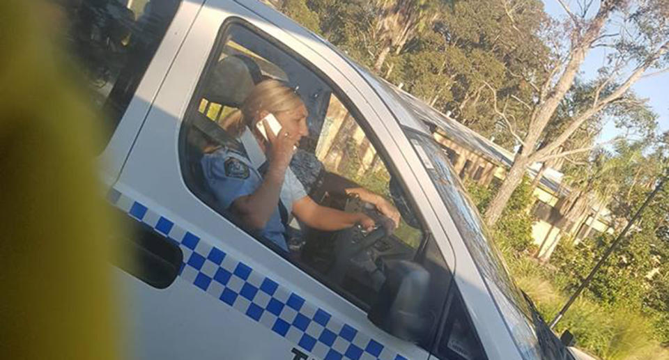 The image of the NSW officer on the phone sparked outrage as to whether or not it’s fair. Source: Facebook