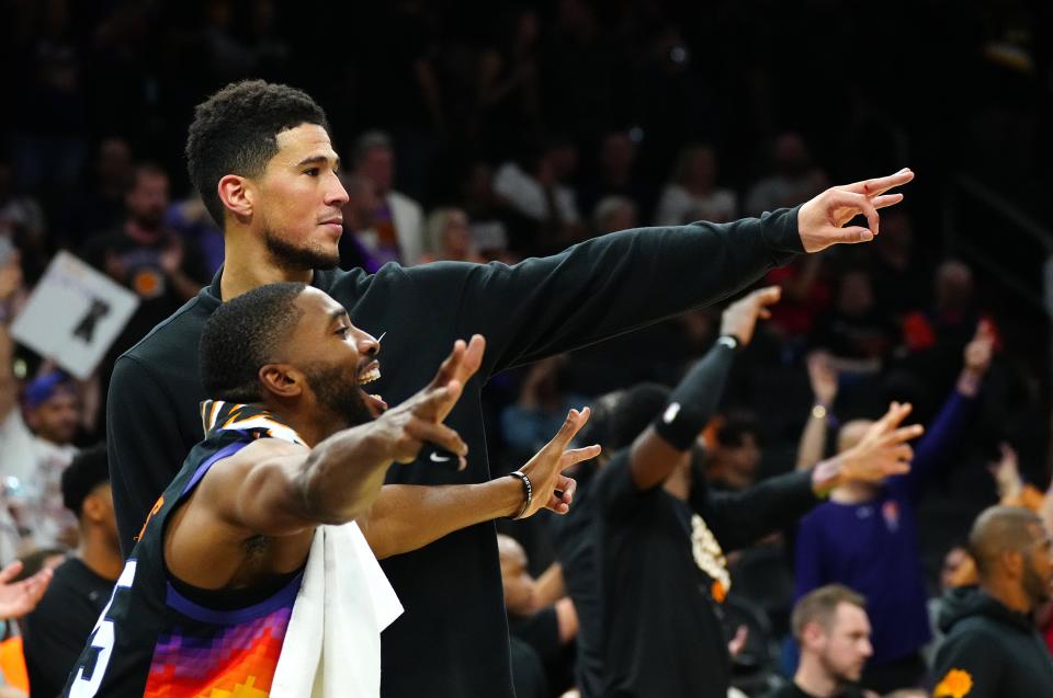May 10, 2022; Phoenix, Arizona; USA; Suns guard Devin Booker and forward Mikal Bridges celebrate a three pointer against the Mavericks during game 5 of the second round of the Western Conference Playoffs.
