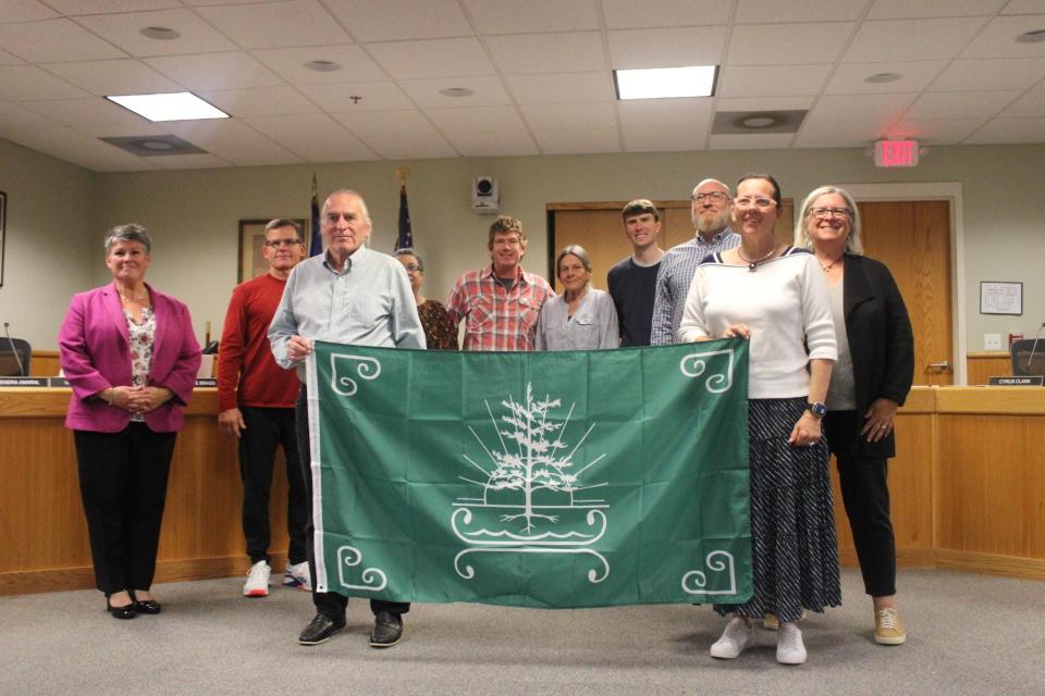 Denise and Paul Pouliot, head speakers of the Cowasuck Band of Pennacook-Abenaki people in Alton, New Hampshire, presented the Kittery Town Council and Town Manager Kendra Amaral with a tribal flag at the council's meeting on Monday, Sept. 25, 2023. Behind the Pouliots (from left to right) are Town Manager Kendra Amaral and Town Council members George Dow, Celestyne Bragg, Cyrus Clark, Judy Spiller, Cameron Hamm, Colin McGuire and Mary Gibbons Stevens.