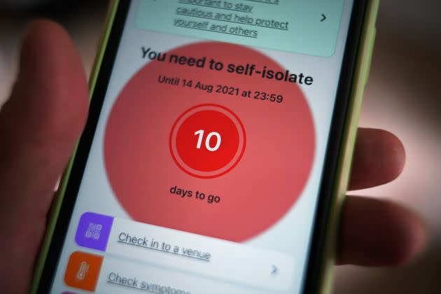 A message to self-isolate is displayed on the NHS coronavirus contact tracing app on a mobile phone (Photo: Yui Mok - PA Images via Getty Images)