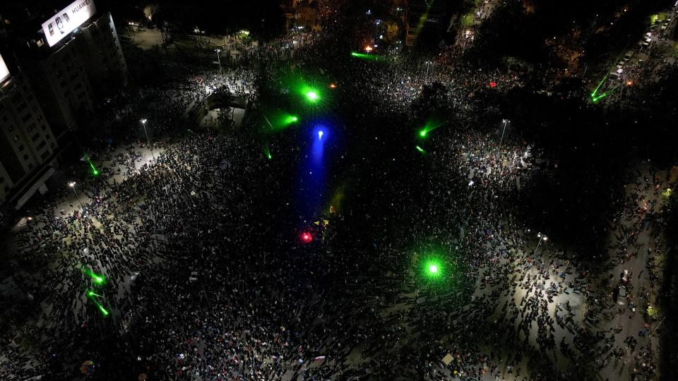 Thousands of people gather on the streets of Santiago, singing, dancing and lighting firecrackersGetty Images