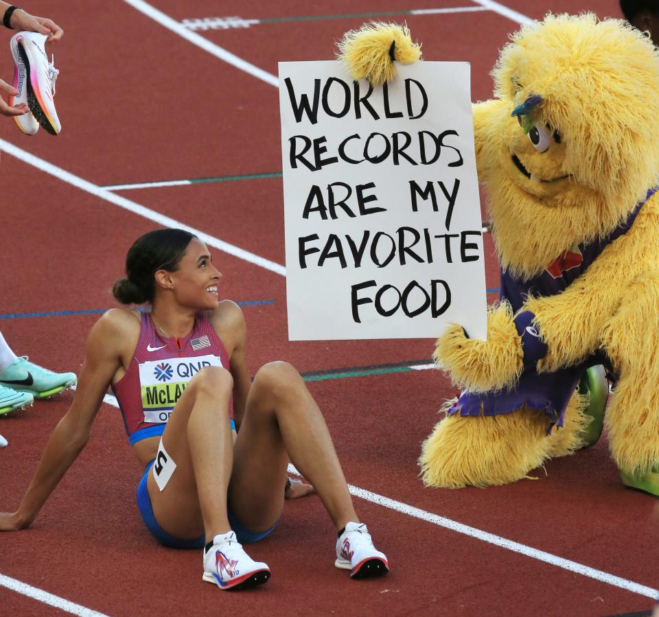 Legand the Bigfoot shows USA's Sydney McLaughlin a sign after her world record performance in the women's 400 hurdles during day eight of the World Athletics Championships at Hayward Field in Eugene on Friday.