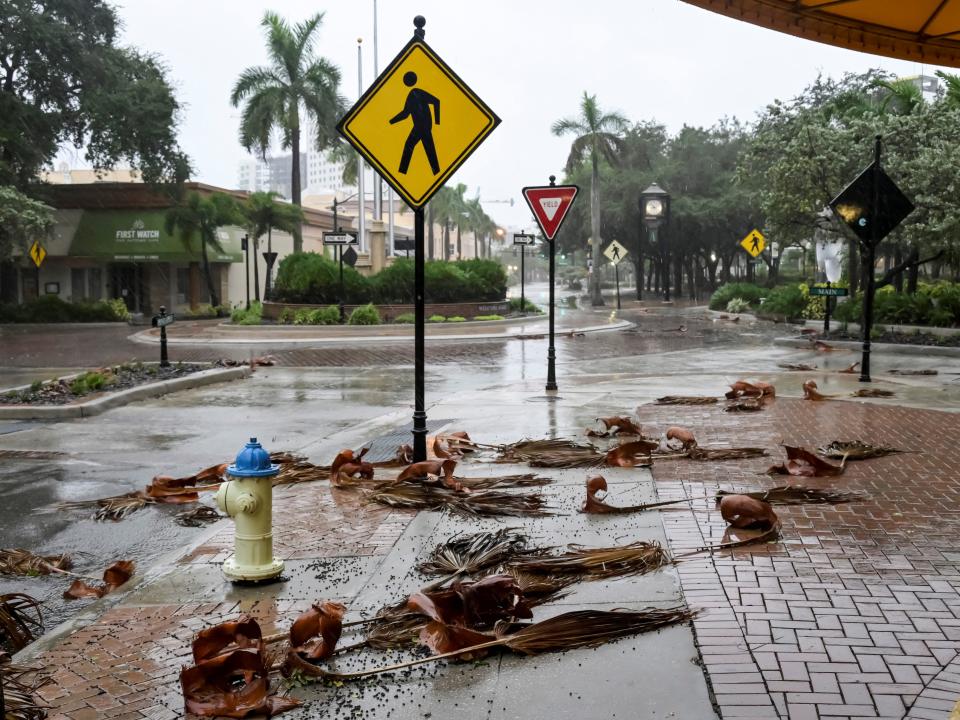 Downed palm fronds collect on an empty downtown intersection as Hurricane Ian approaches Florida’s Gulf Coast in Sarasota, Florida, U.S. September 28, 2022.