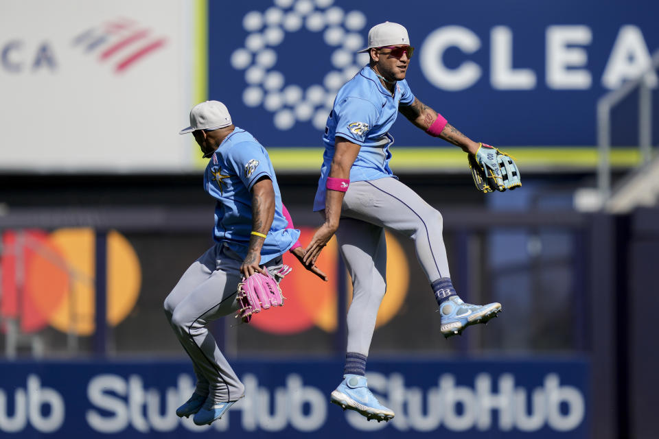 Tampa Bay Rays center fielder Jose Siri, right, celebrates with shortstop Wander Franco, left, after catching the final out on a long fly ball hit by New York Yankees' Aaron Judge to close the ninth inning of a baseball game, Sunday, May 14, 2023, in New York. (AP Photo/John Minchillo)