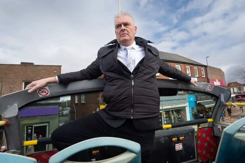 Lee Anderson standing at the front of the open-top bus