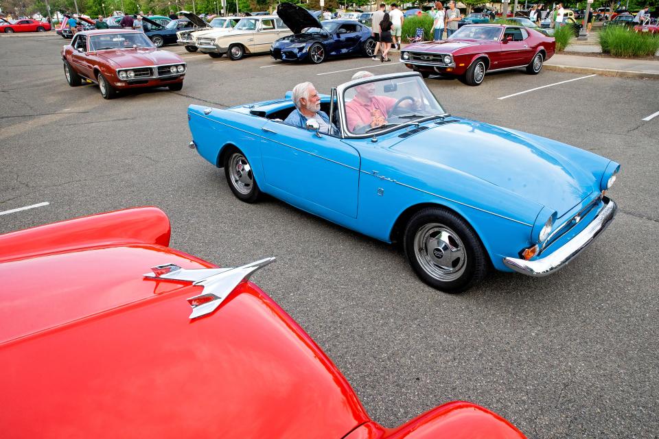 Brothers Jim, 74, at left, and Robert Praetzel, 79, ride in RobertÕs 1966 Sunbeam Tiger, a gift from his sons, on June 13, 2022, during the Bayfront Monday Night Car Cruise-In at the Highmark Liberty Park Amphitheater on ErieÕs bayfront. Robert, from Erie, had purchased a very similar, brand-new car in 1966, which he used to visit his then-girlfriend Paula, now his wife of 56 years. In 1971, after the birth of his sixth child, Robert Praetzel was forced to sell his beloved British-made car to expand his home and make room for his six sons. On his 50th wedding anniversary, Robert received as a gift from his sons a car that was very similar to his original car. His sons had spent 7 years looking for the car and made it even better than the original by having it specially redesigned with a Carroll Shelby V-8 engine. The Monday Night Cruise-In takes place weekly through the summer. Contact Michael Lytle at 814-403-7121 for information.